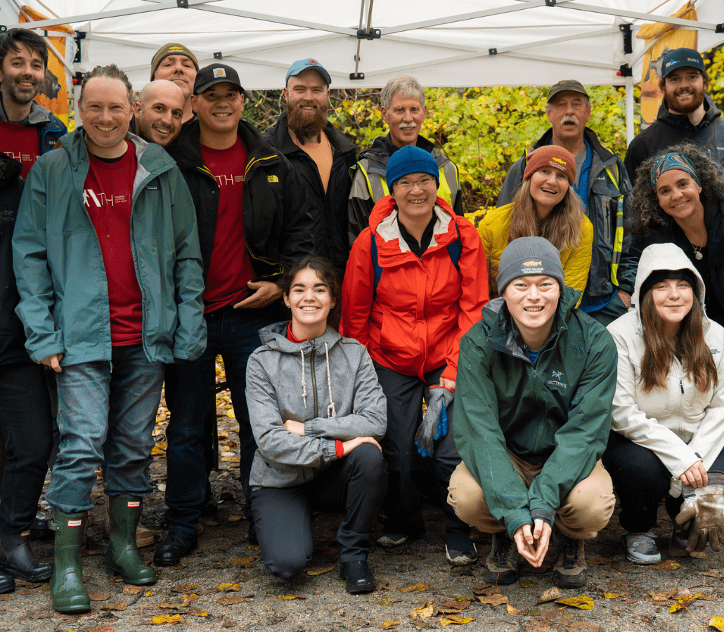 Volunteers gather under a tent once the salmon habitat restoration work is complete. 