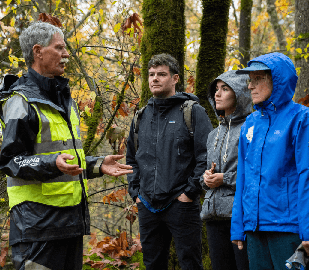 A streamkeeper explains habitat restoration efforts to volunteers near Lynn Creek.