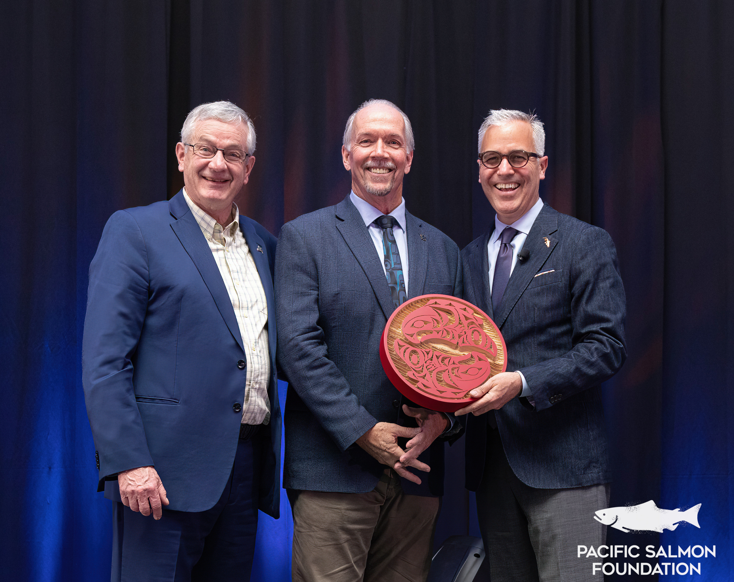 Former Premier John Horgan poses with Brian Riddell and PSF's Michael Meneer at PSF's South Vancouver Island fundraiser event in 2023.