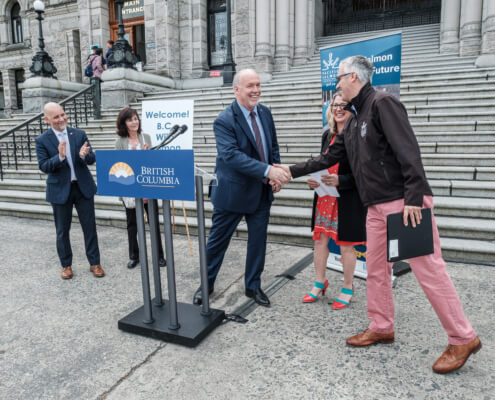 Former Premier John Horgan shakes hands with PSF's Michael Meneer in 2019 at the Wild Salmon Day event at the B.C. Legislature in Victoria.