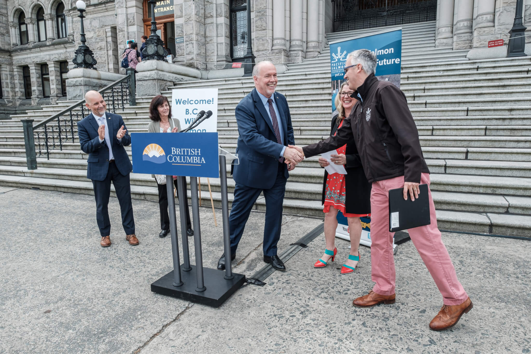 Former Premier John Horgan shakes hands with PSF's Michael Meneer in 2019 at the Wild Salmon Day event at the B.C. Legislature in Victoria.