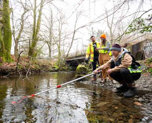 A group of researchers samples the Chase River for contaminants near a bridge. Photo: Vancouver Island University
